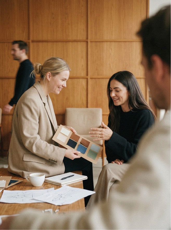 Two colleagues reviewing fabric color swatches, illustrating core systems